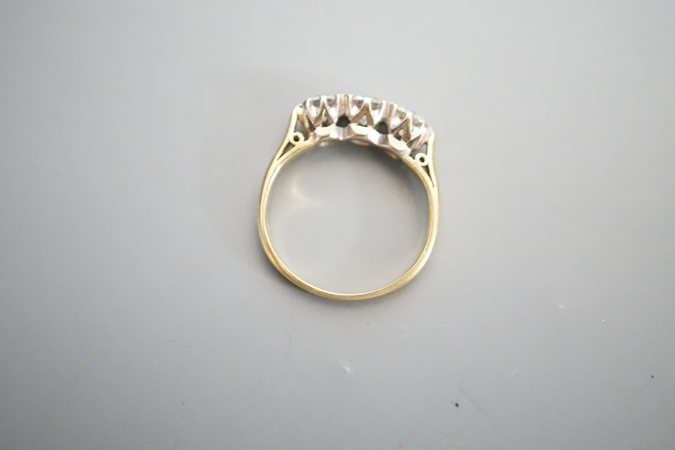 A modern 18ct gold and three stone diamond ring, size L, gross weight 3.3 grams